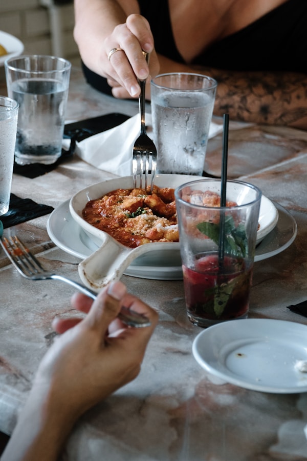 A woman sitting at a table with a plate of food