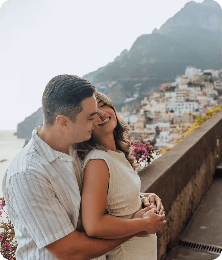 A man and a woman embracing each other on a balcony.