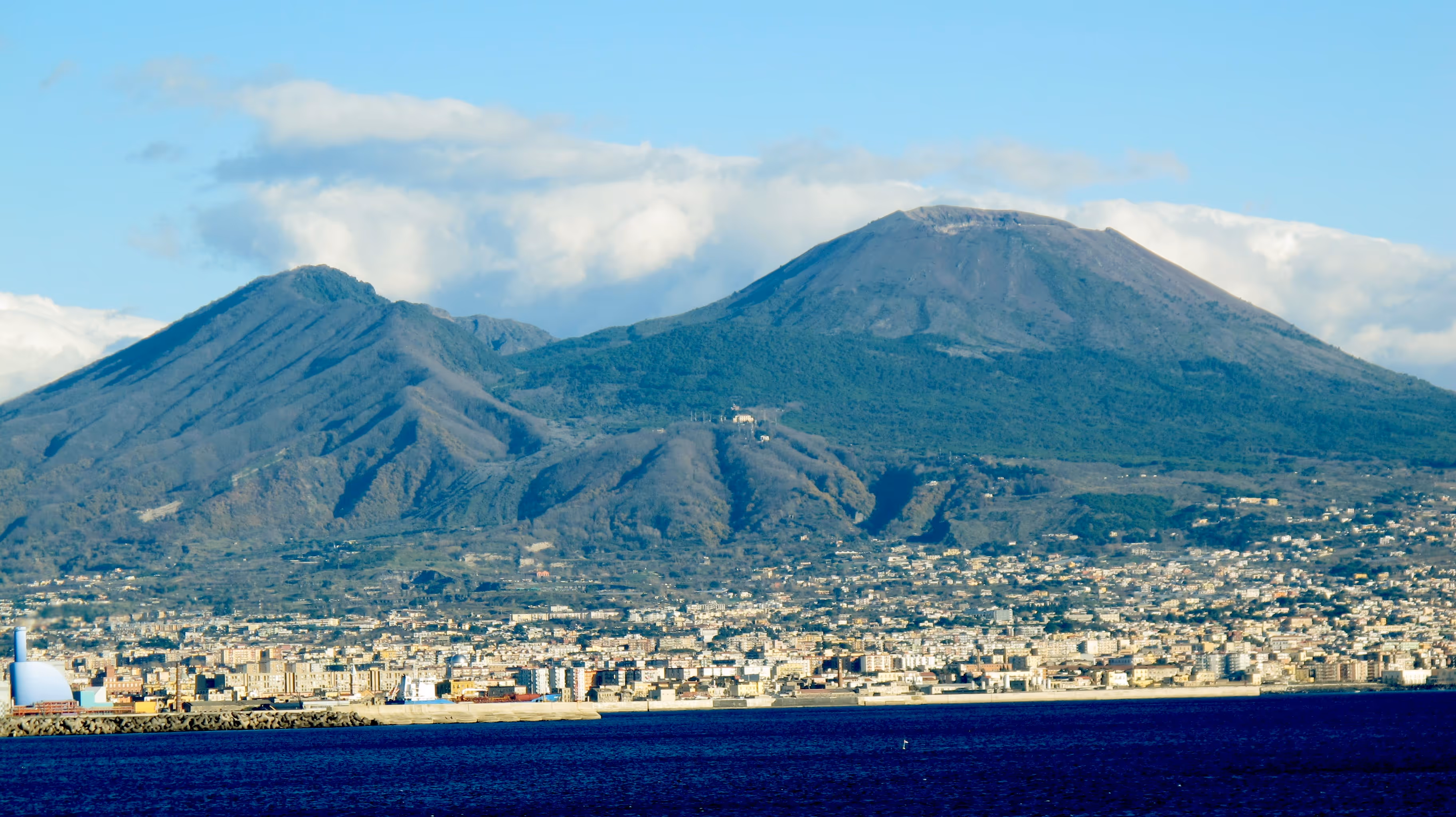 A view of a city with a mountain in the background.