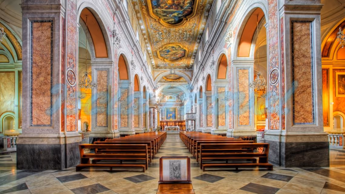 A church filled with wooden pews and a painting on the wall.