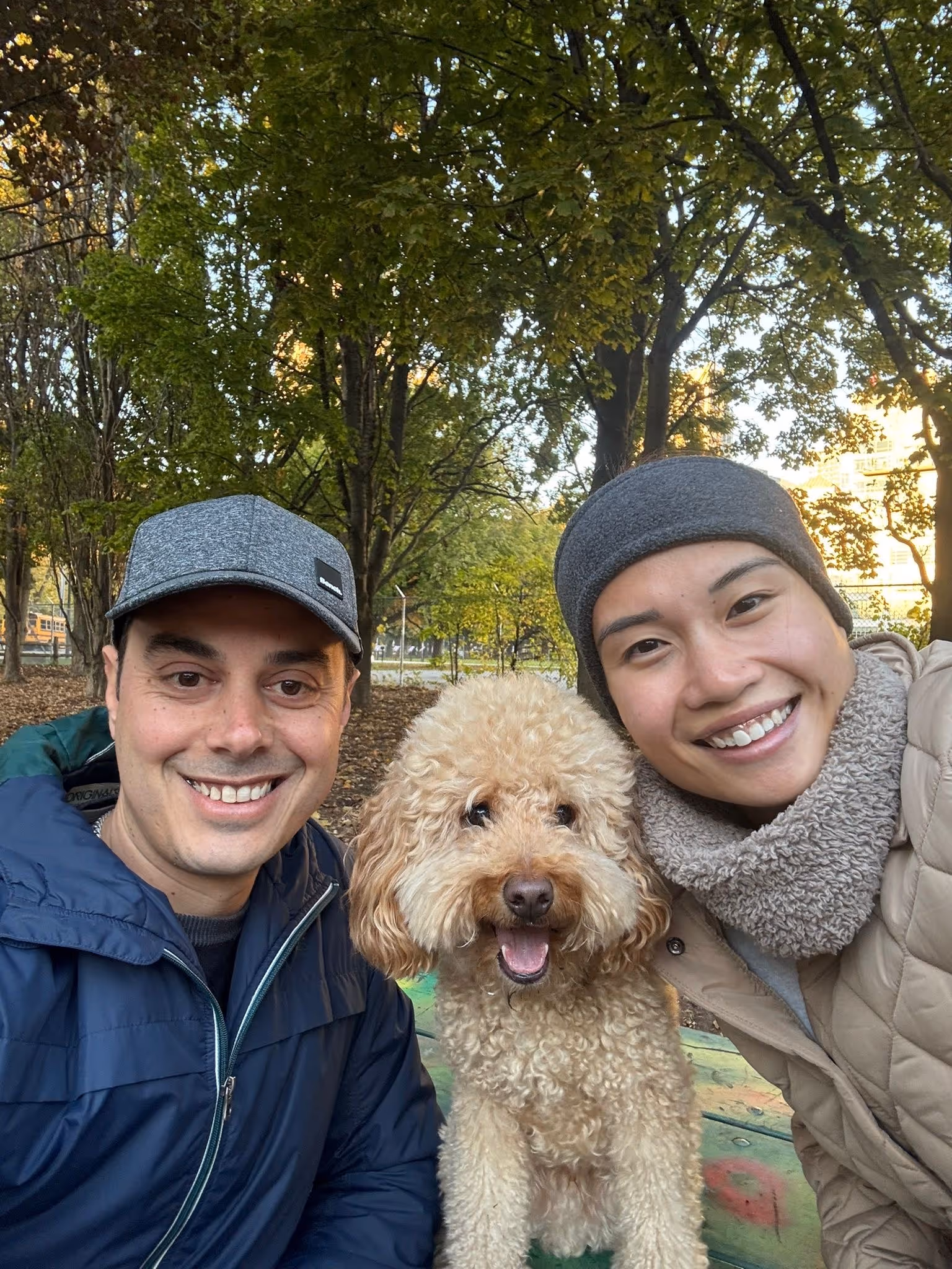 A man and a woman pose for a picture with a dog.