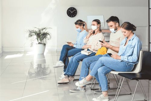People in masks using phones, illustrating healthcare technology and data integration.