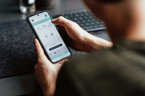 A person holding a phone with the health data