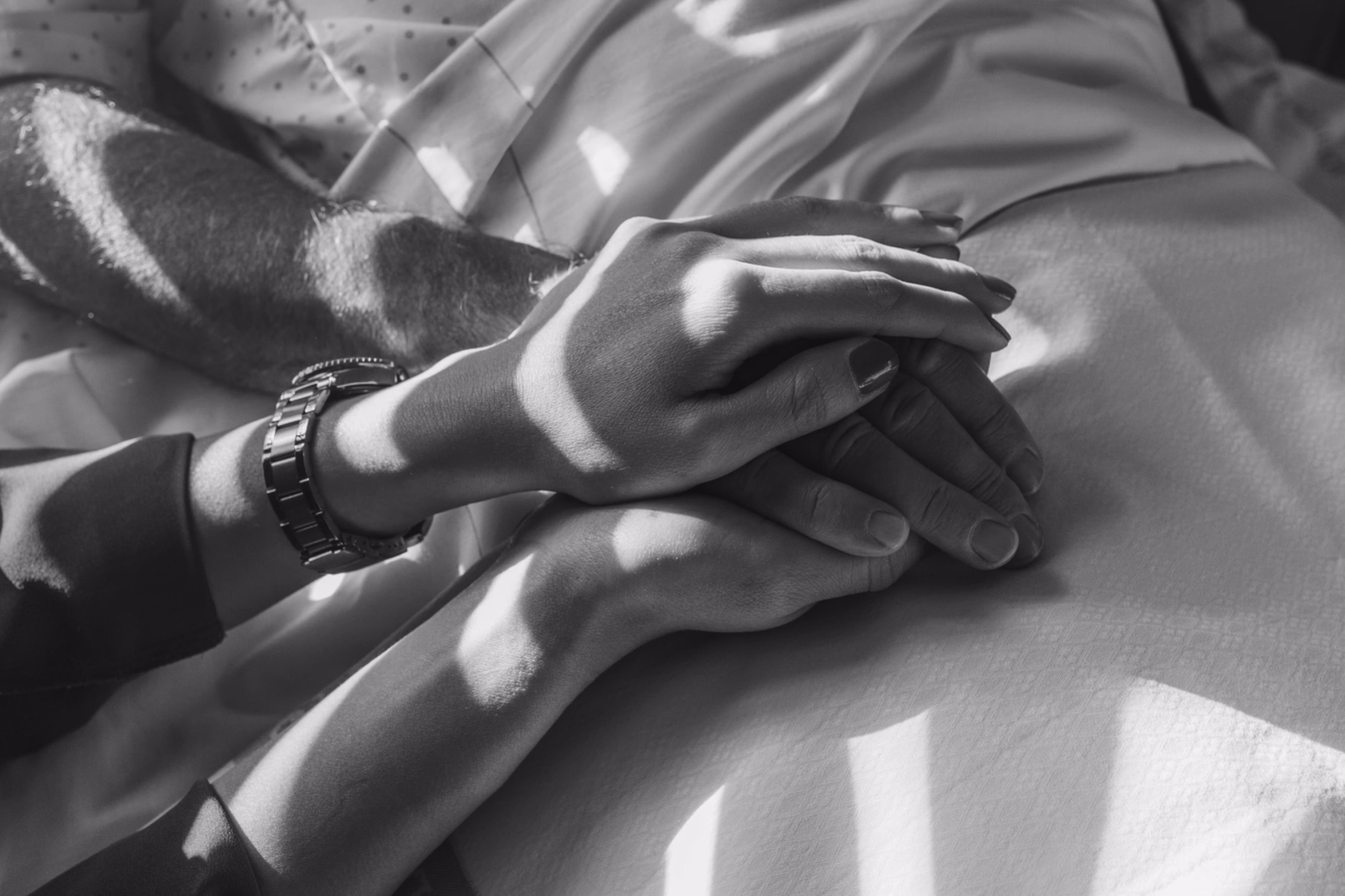 Healthcare professional holding a patient’s hand in a moment of reassurance and support.