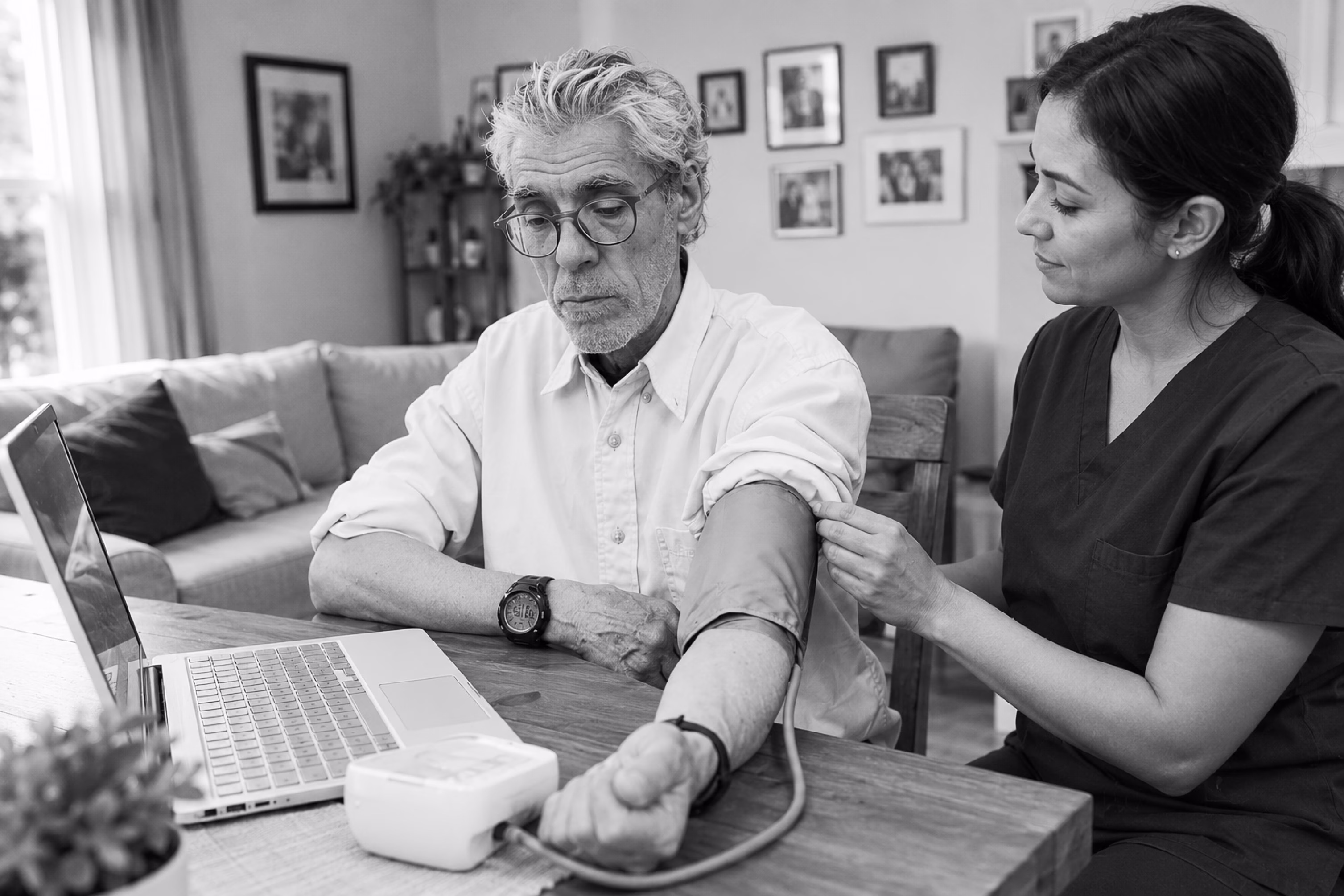 Healthcare professional monitoring an older patient’s blood pressure