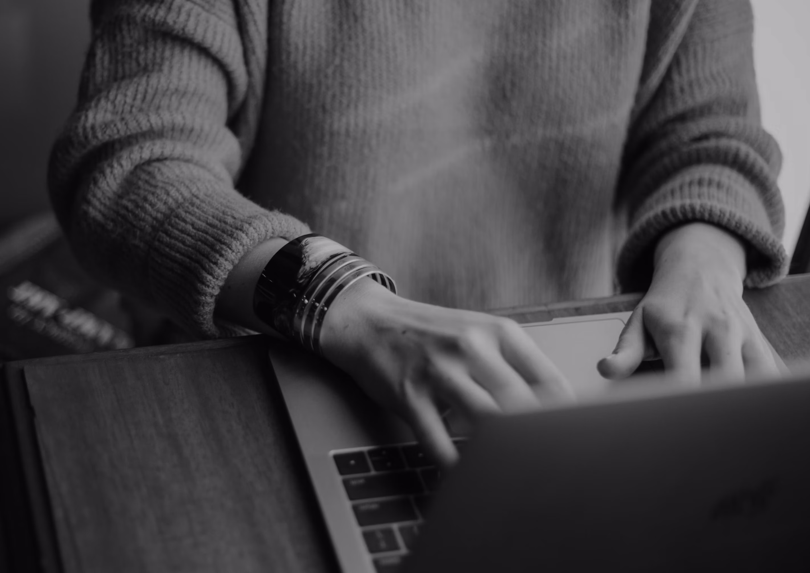 Skilled nursing professional working on a laptop at a desk.