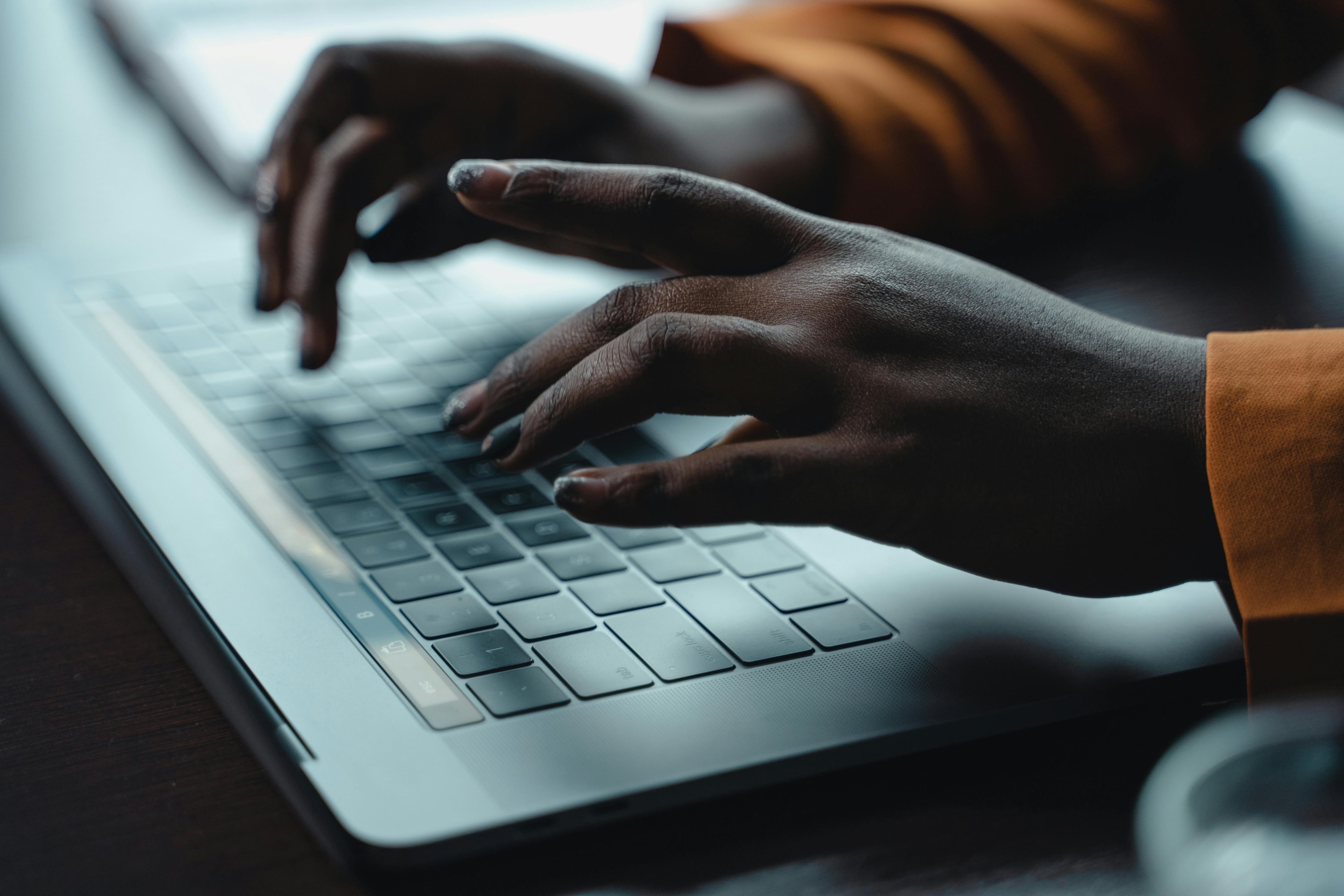 Someone typing on a laptop.