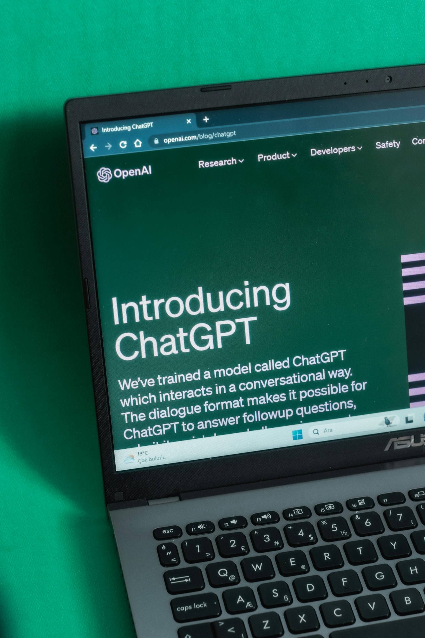 A laptop screen that states "Introducing ChatGPT".