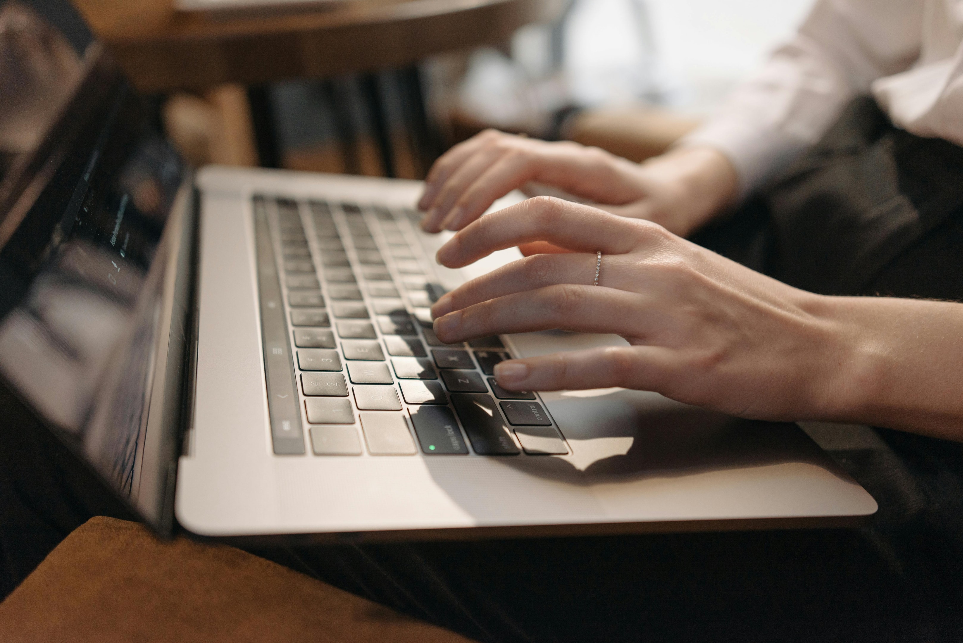Someone typing on a Laptop.