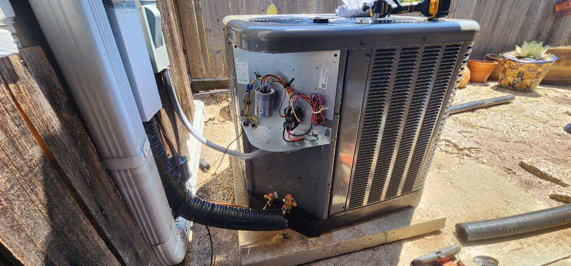 Air conditioning unit with open panel showing internal electrical components