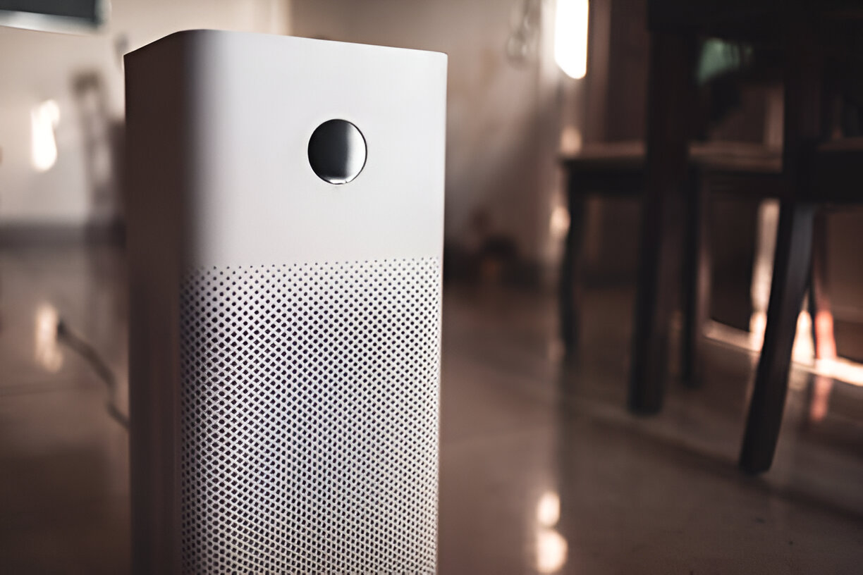 White air purifier with circular design on blurred background