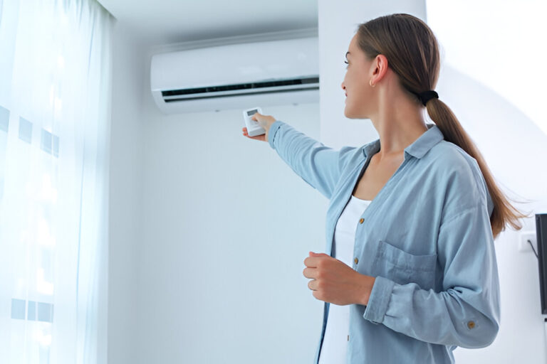 Lady holding remote of AC to adjust it