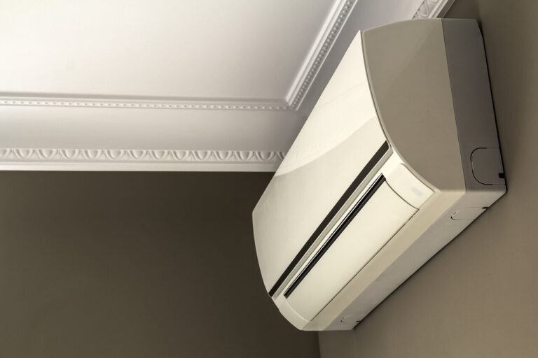 Modern air conditioner system mounted on dark wall in living room