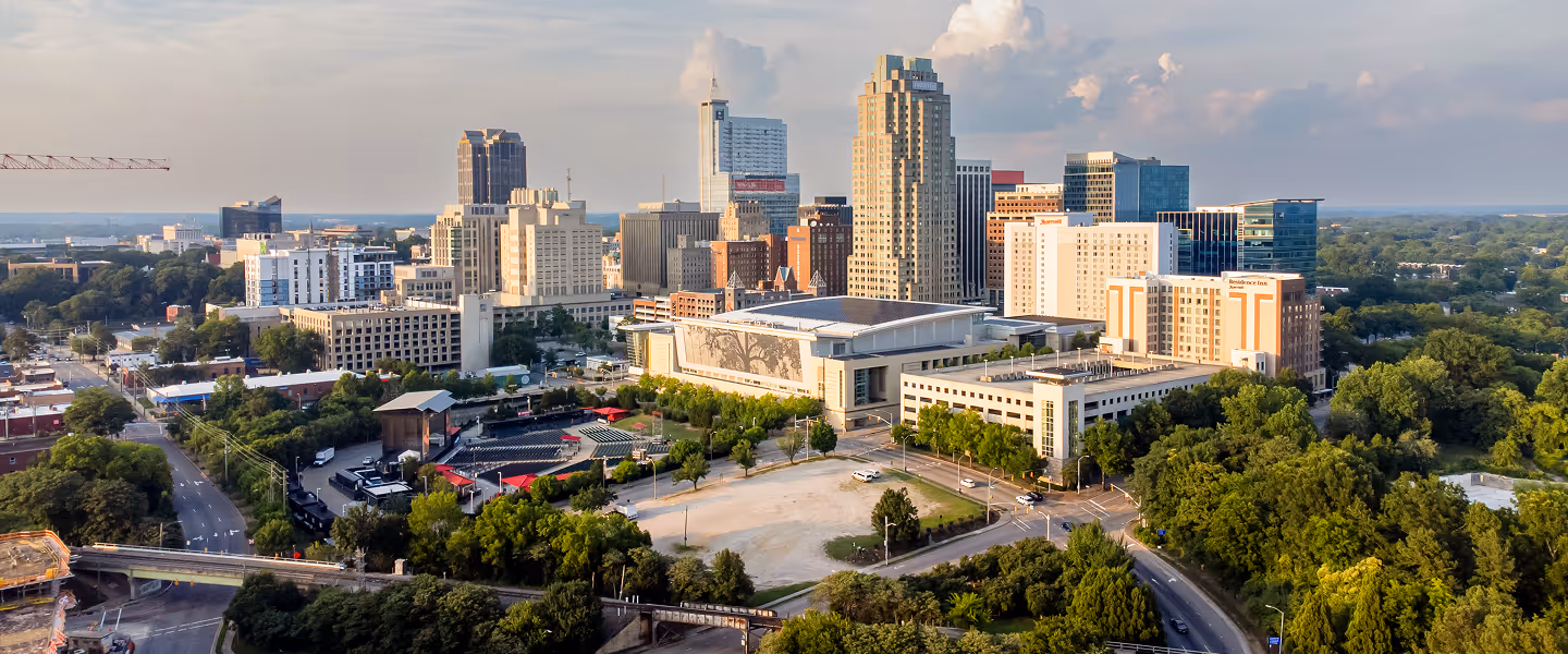 Raleigh skyline with downtown skyscrapers and green trees