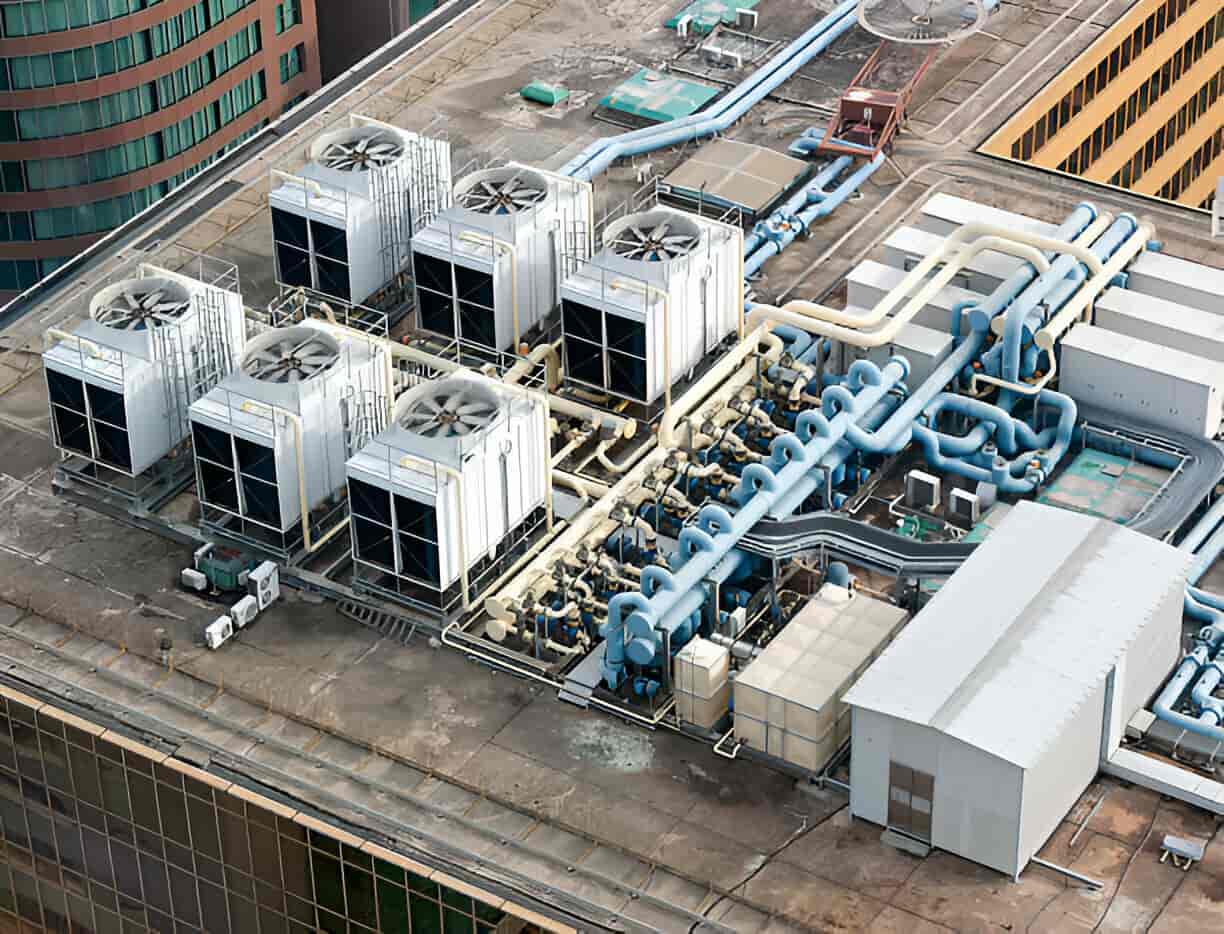 Aerial view of industrial cooling system with large fans and complex piping
