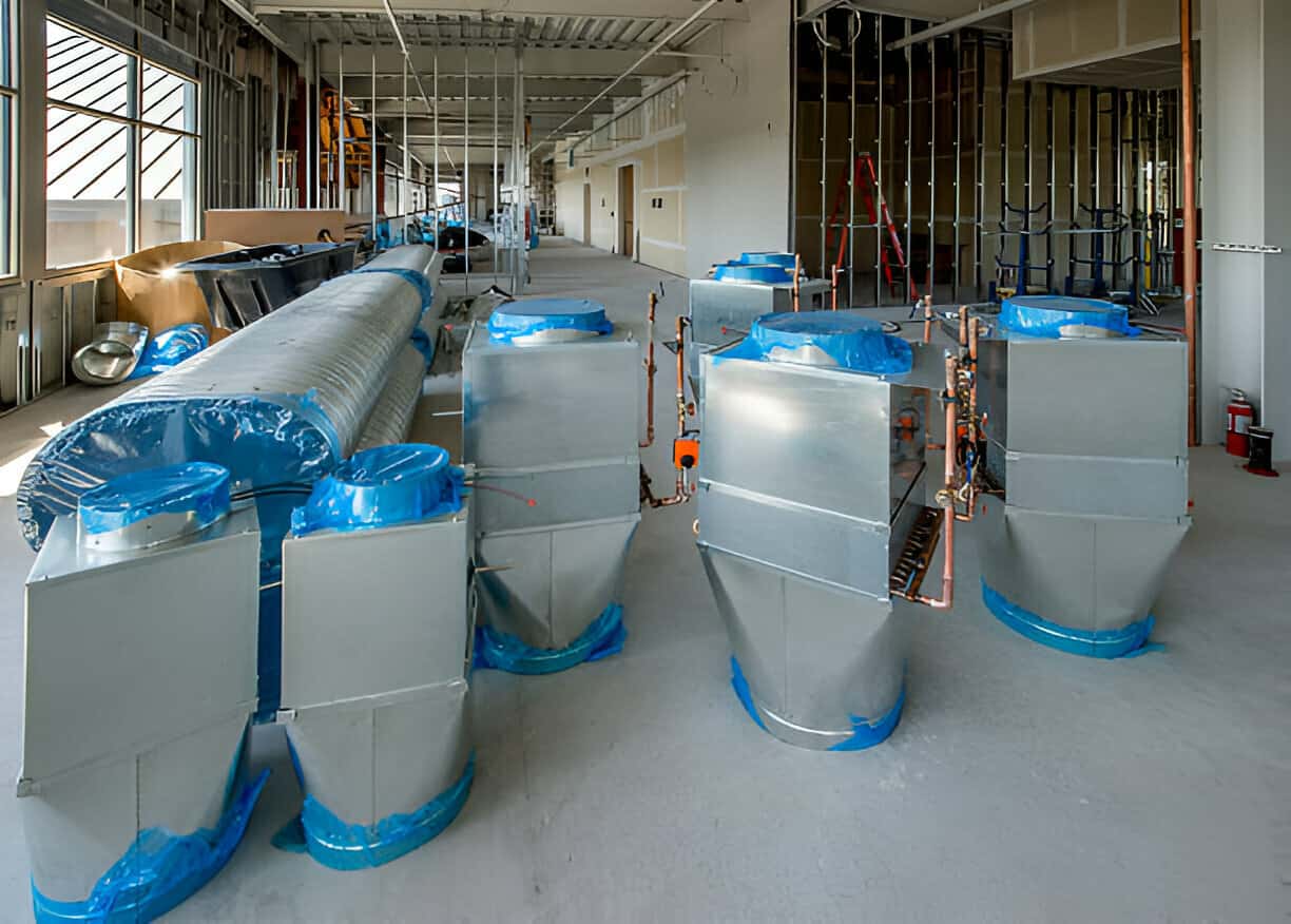 Industrial facility with large metal containers and blue protective coverings