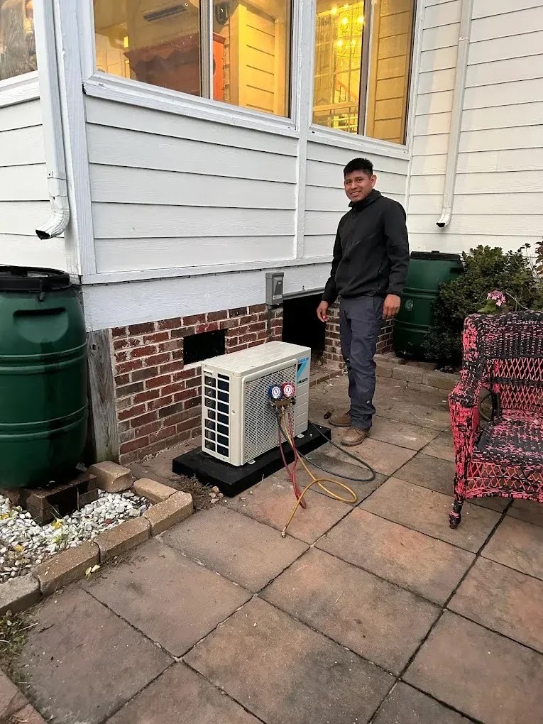 Technician inspecting an air conditioning unit in a home setting