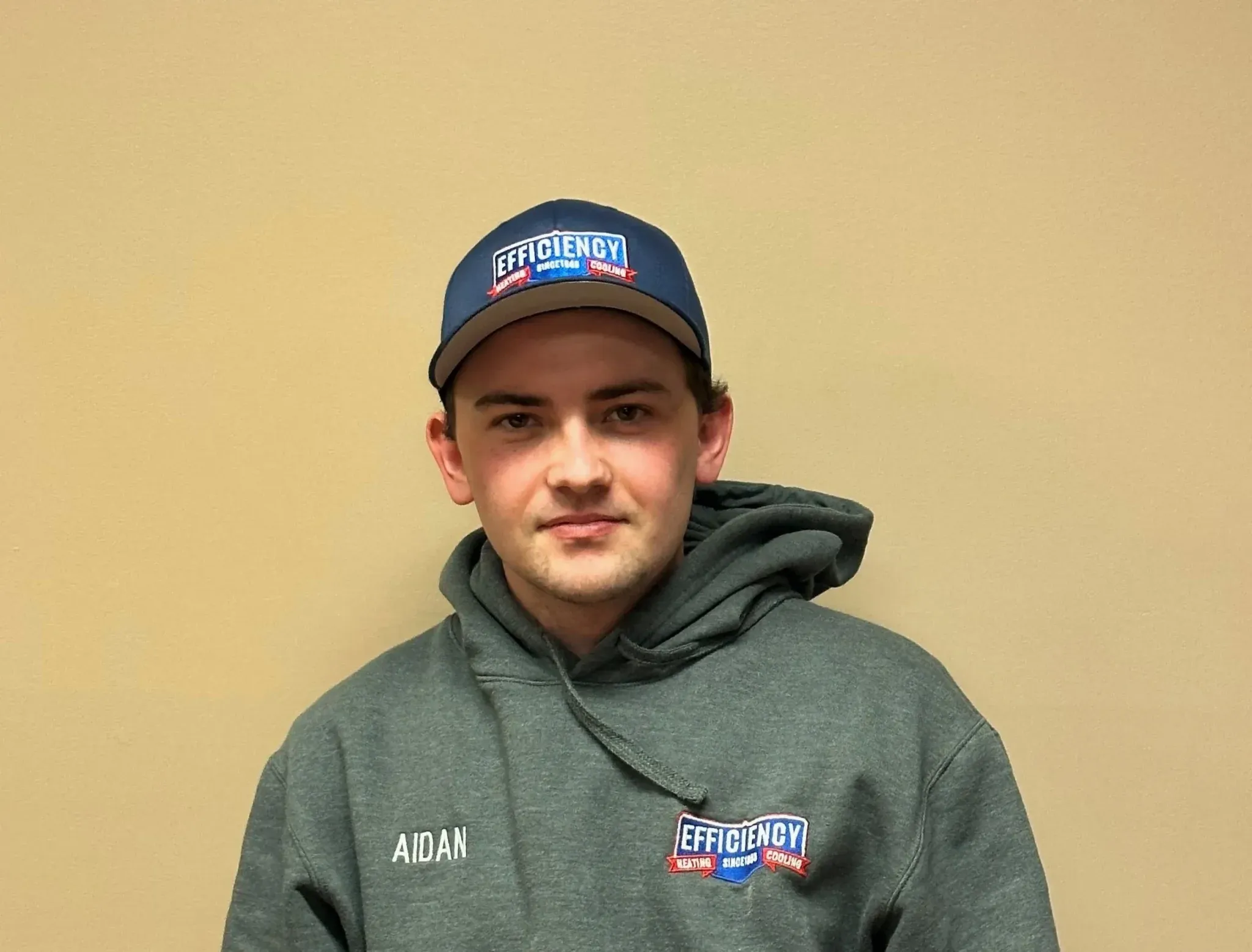 Employee in Efficiency Heating and Cooling branded hoodie and cap