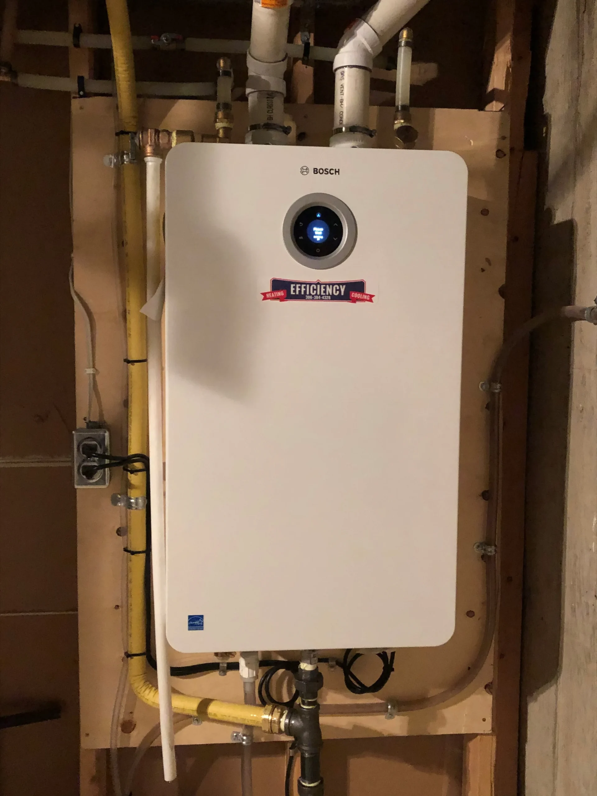 Bosch efficiency water heater installed on basement wall with pipes