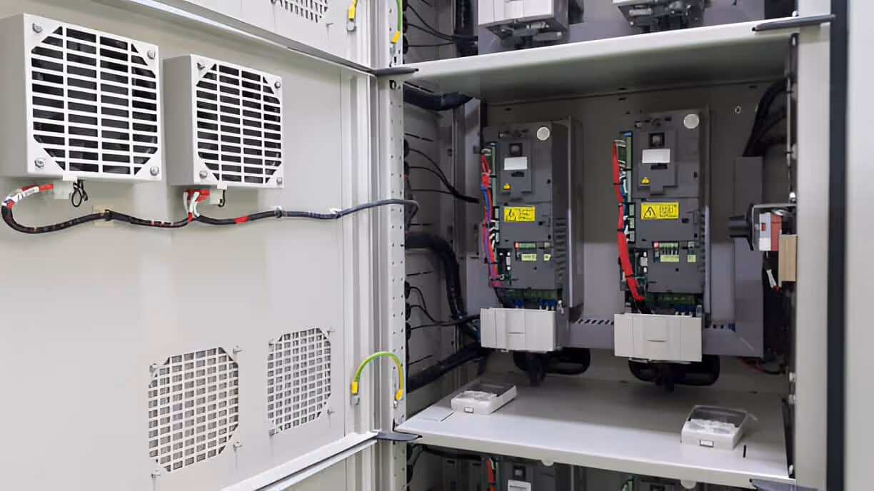 Industrial electrical control cabinet with ventilation fans and circuit breakers