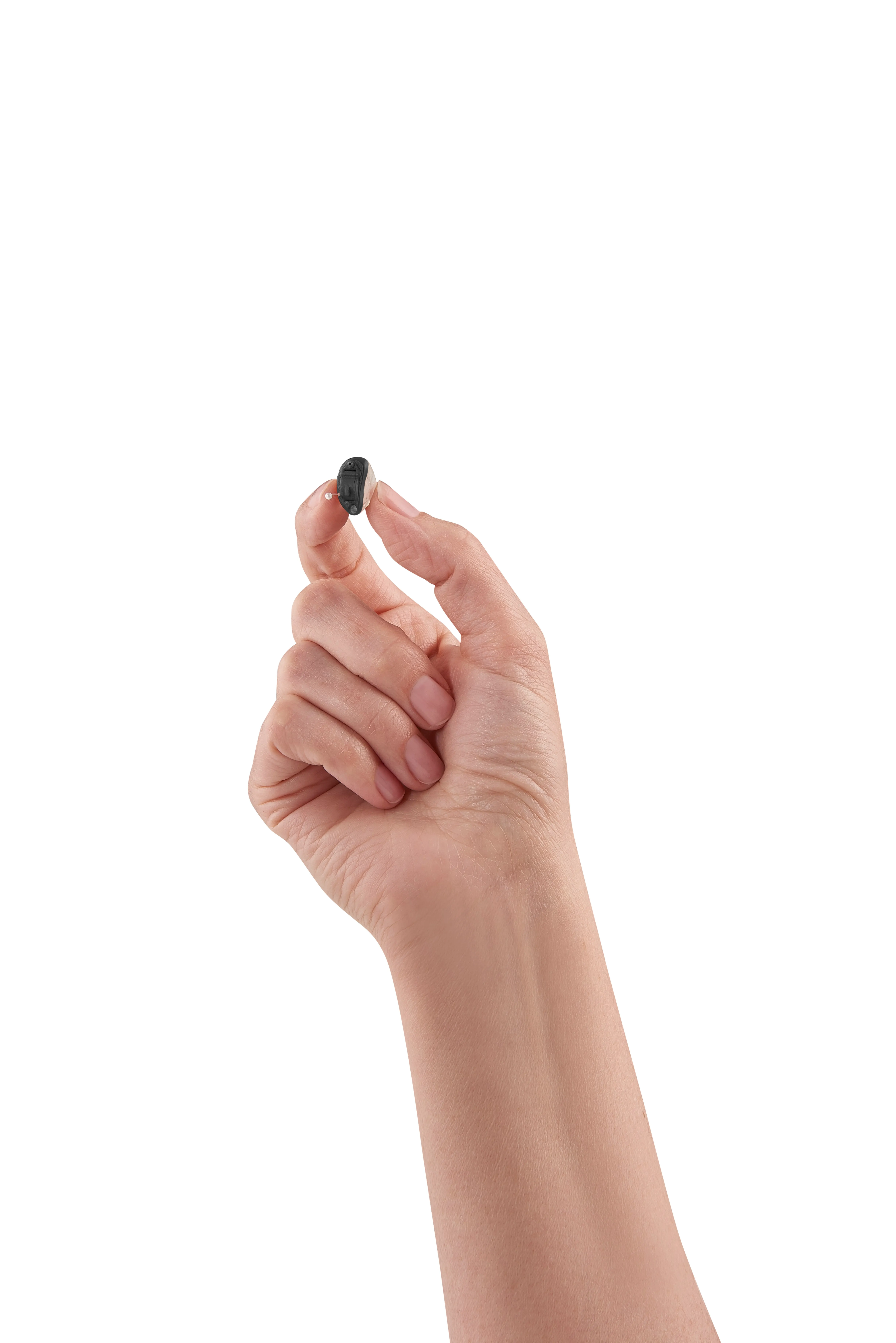 Hand holding small black hearing aid against white background.