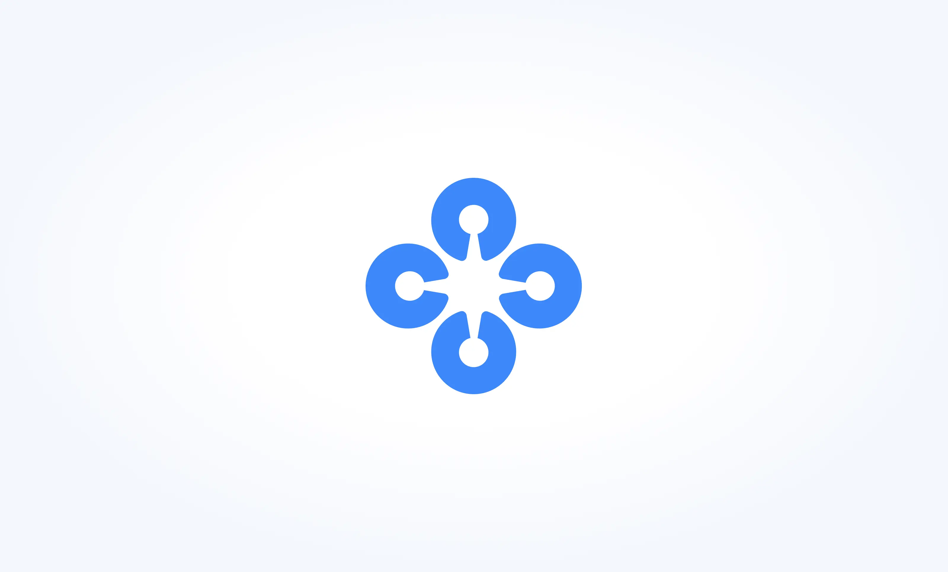 Blue geometric icon composed of four circular shapes arranged in a cross pattern, each with a small central hole and a notch facing the center on a light gradient background.