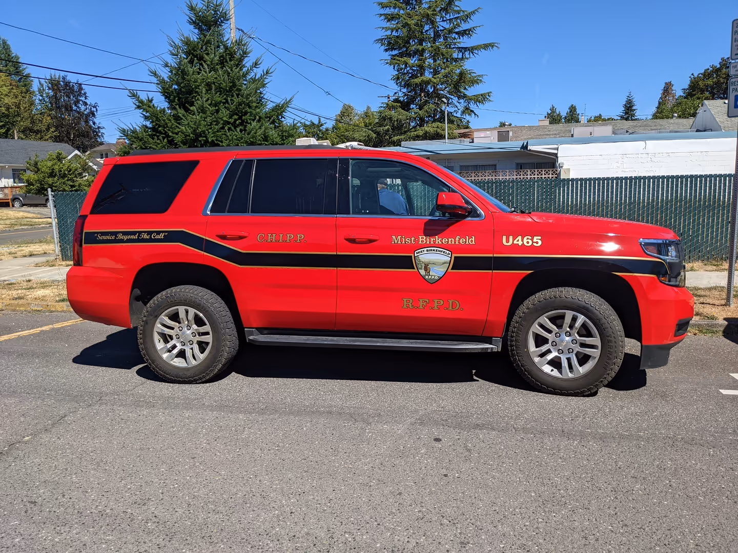 A red police truck parked in a parking lot.