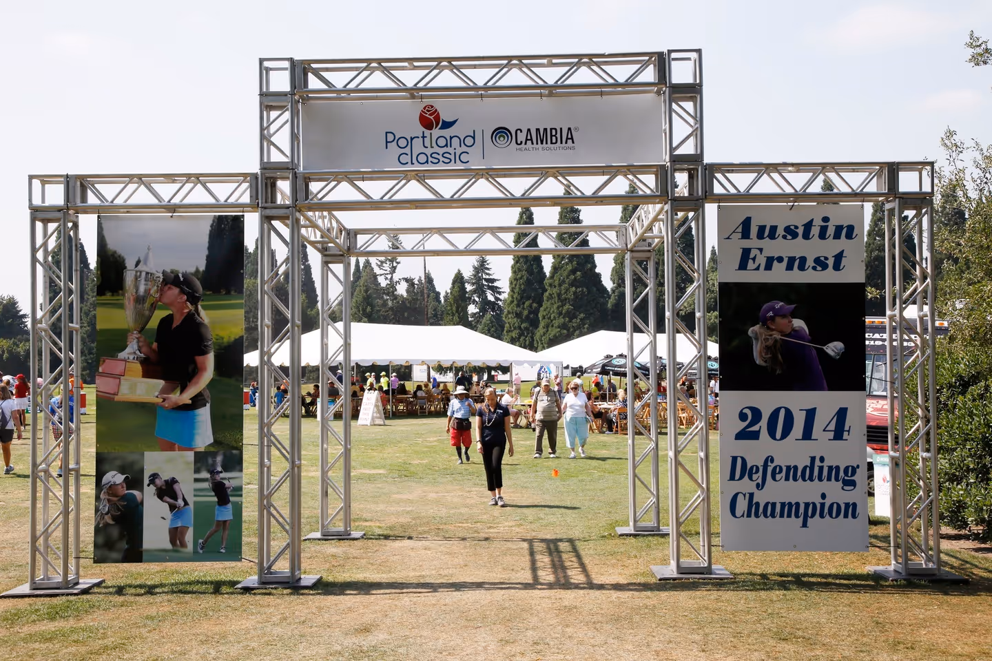 A group of people standing under a metal structure.