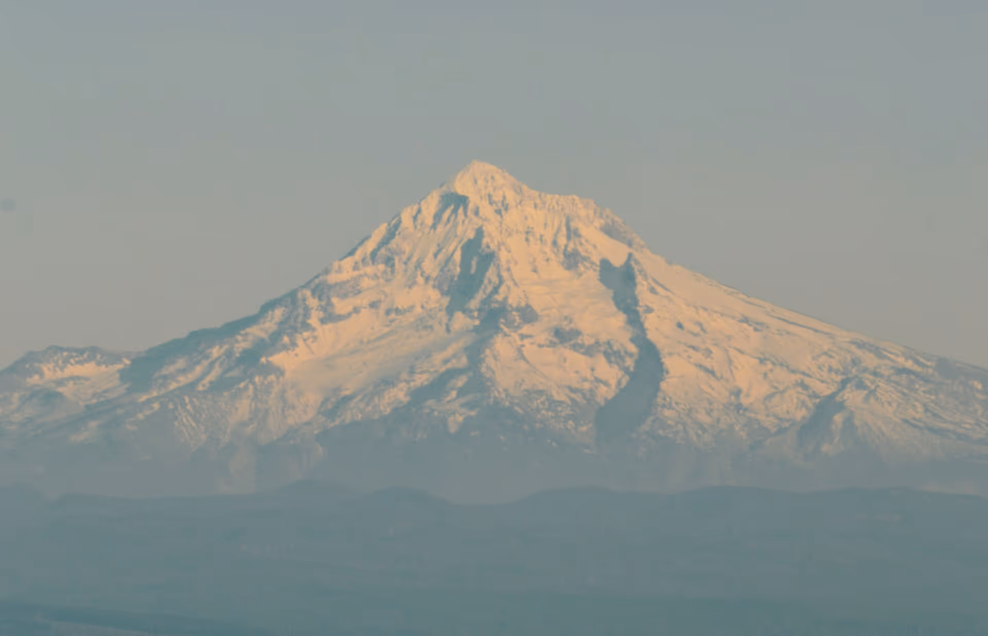 A large snow covered mountain in the distance.