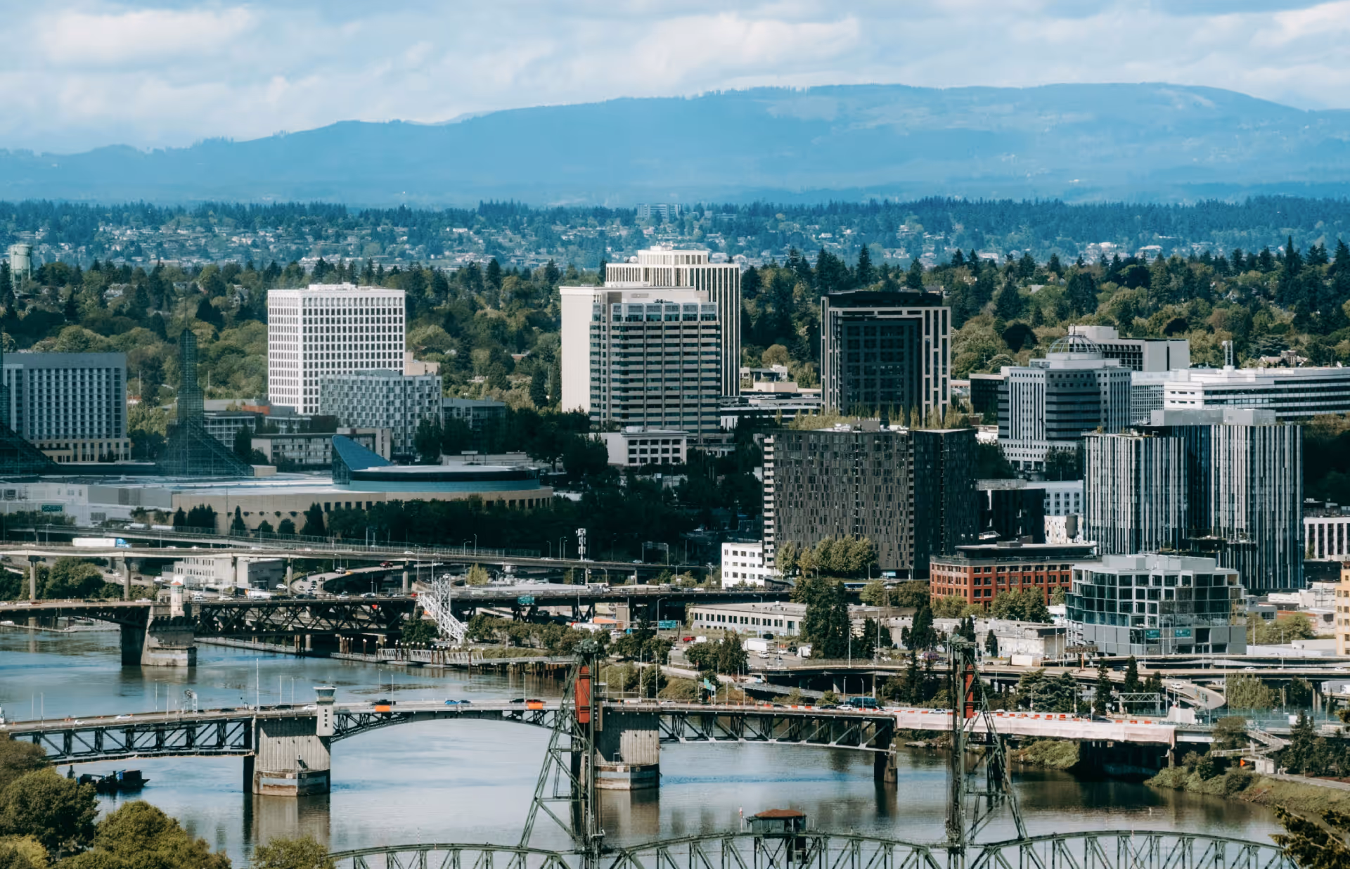 A view of a city with mountains in the background.