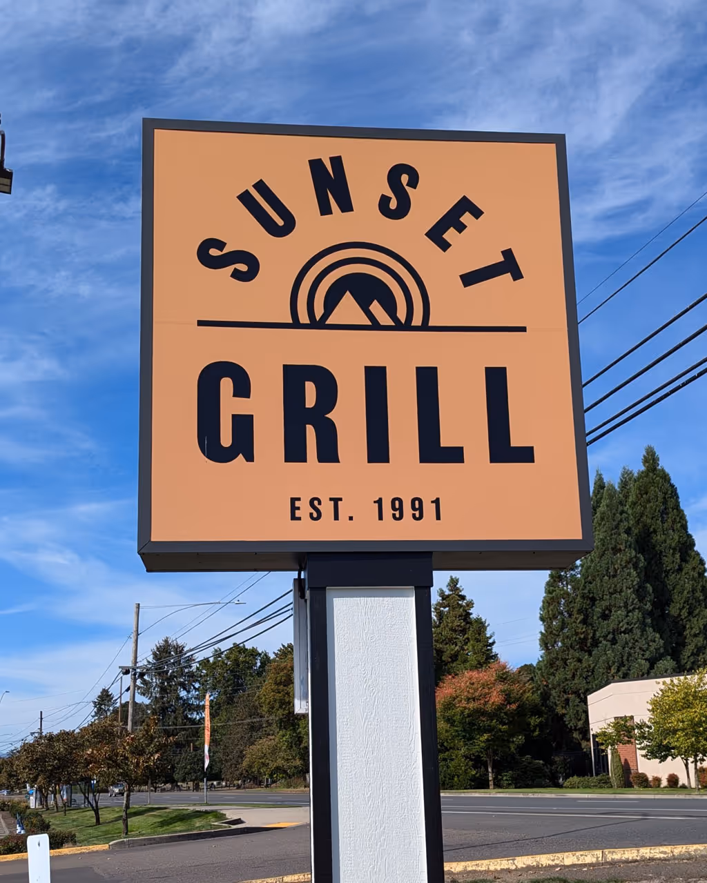 A sign for a restaurant called sunset grill.