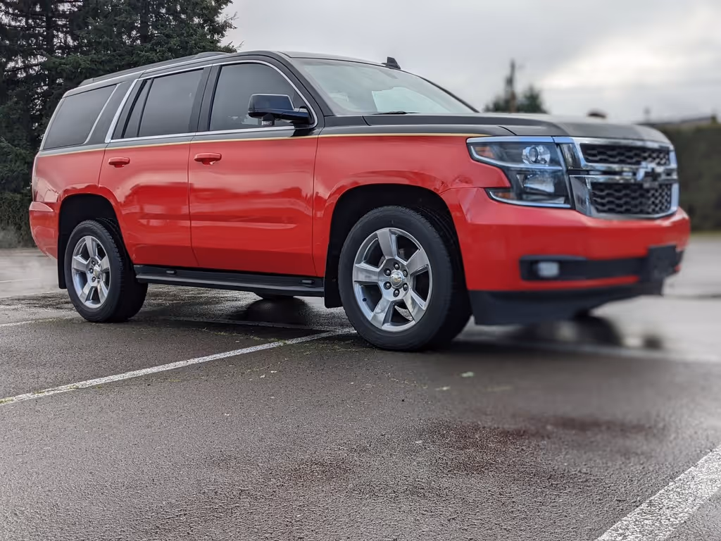 A red suv parked in a parking lot.