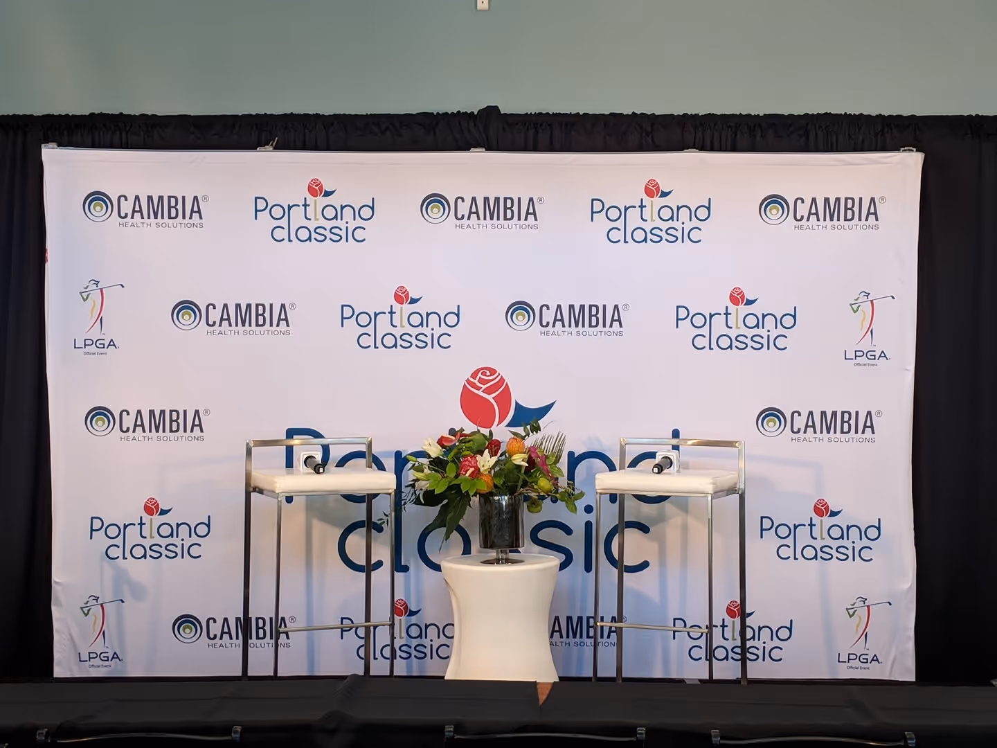 A table with a vase of flowers on top of it.