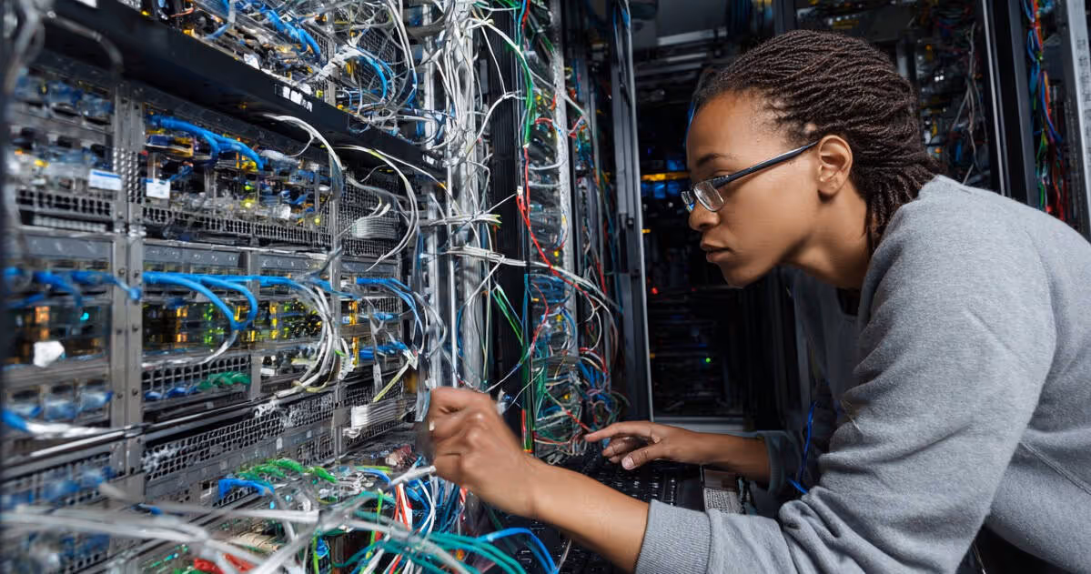 Technician delivering it support and services in a server room