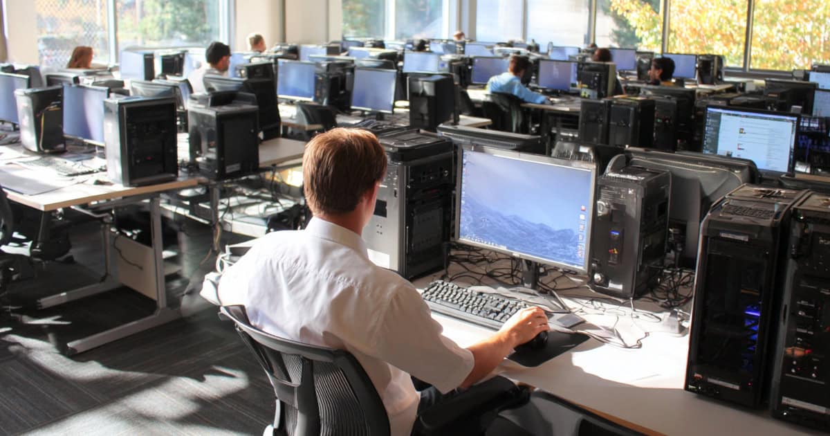 managed service provider setting up a room full of computers at a school