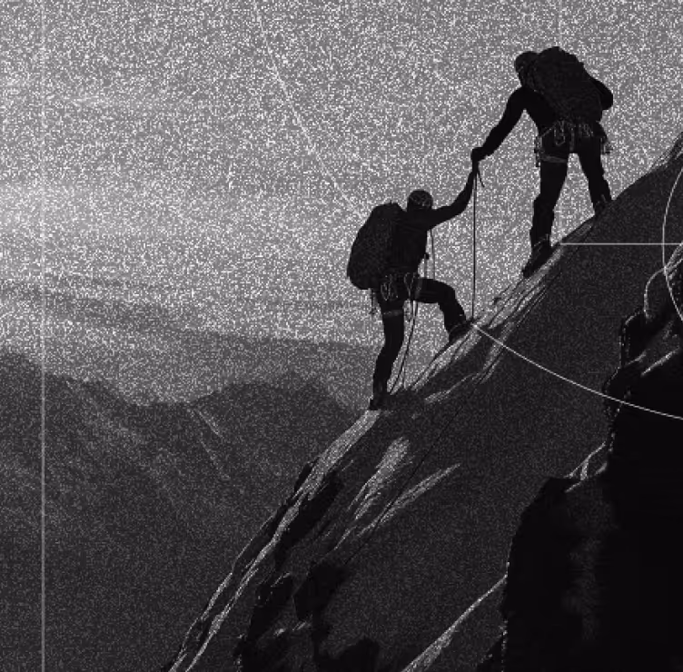 Two people climbing a mountain