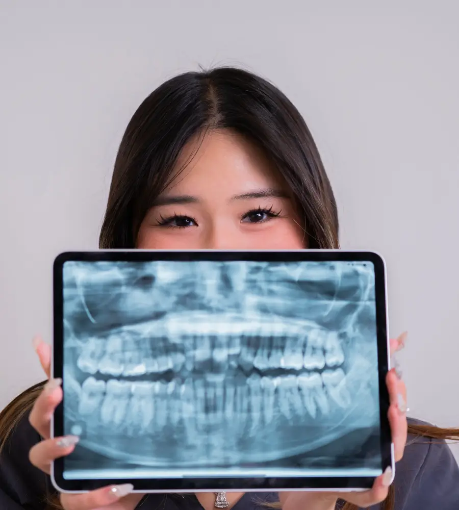 Trusted Dental team member holding an x-ray image