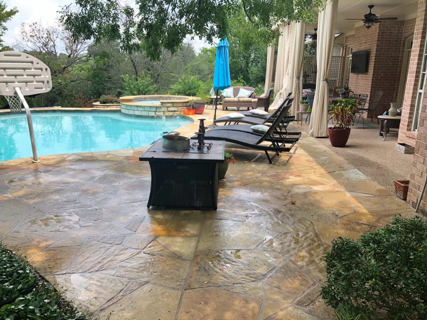 Clean poolside stone patio after professional pressure washing