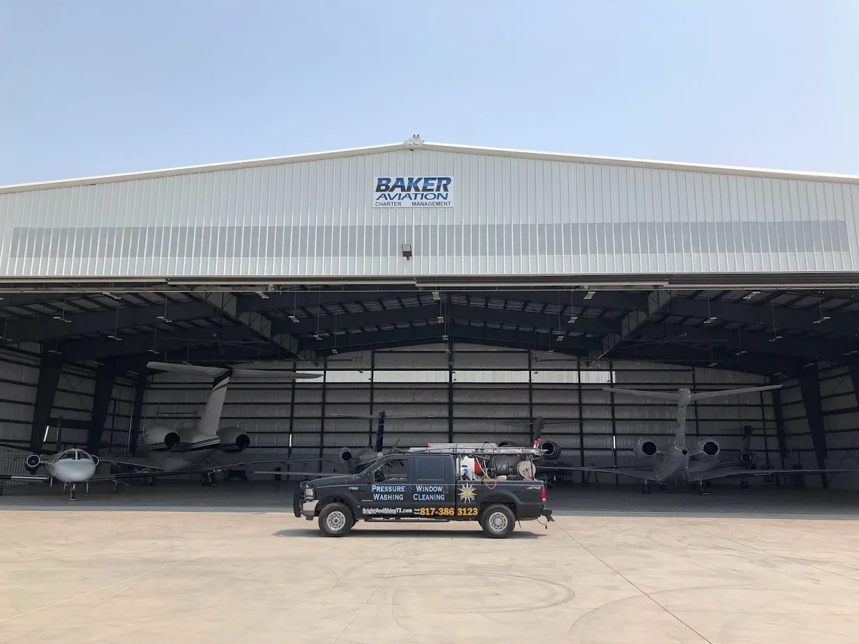 Bright & Shiny service vehicle outside a commercial hangar