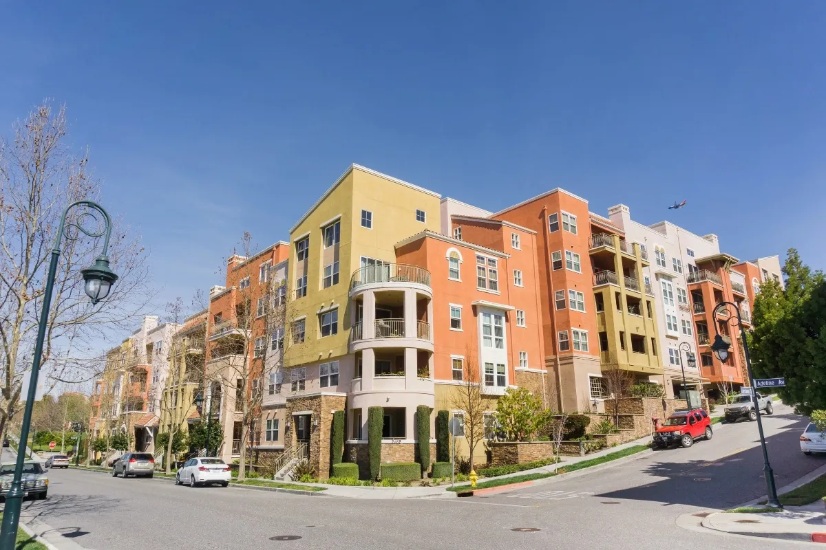 Modern multistory apartment community along a landscaped street