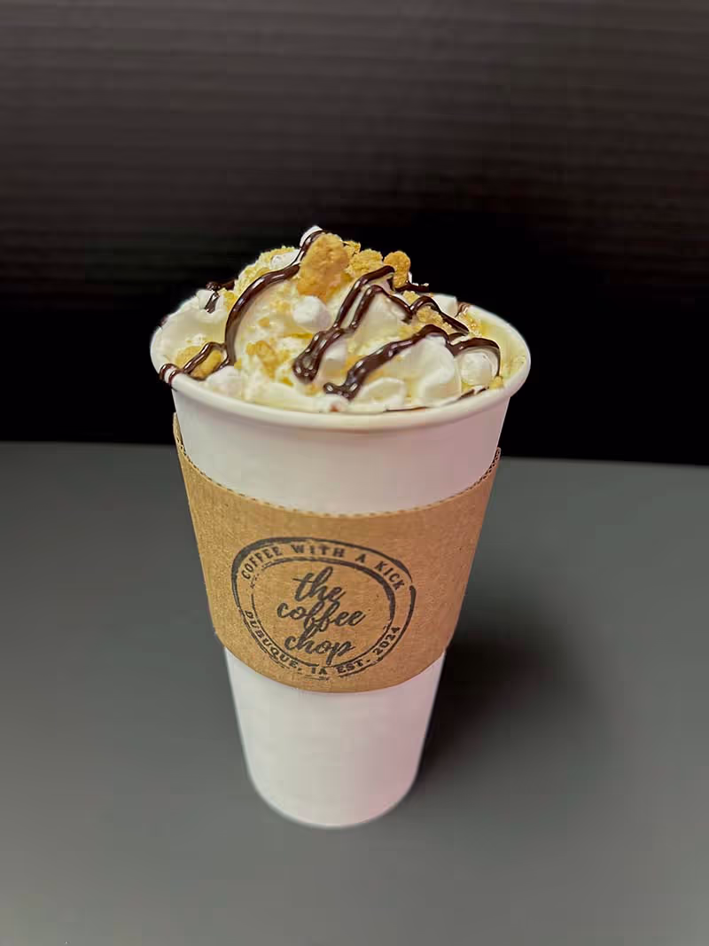 A cup of coffee with a chocolate topping.