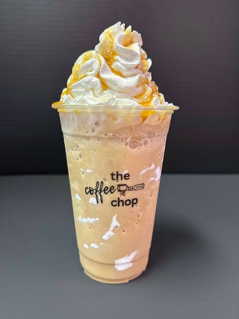 A cup of coffee with a logo on the side.