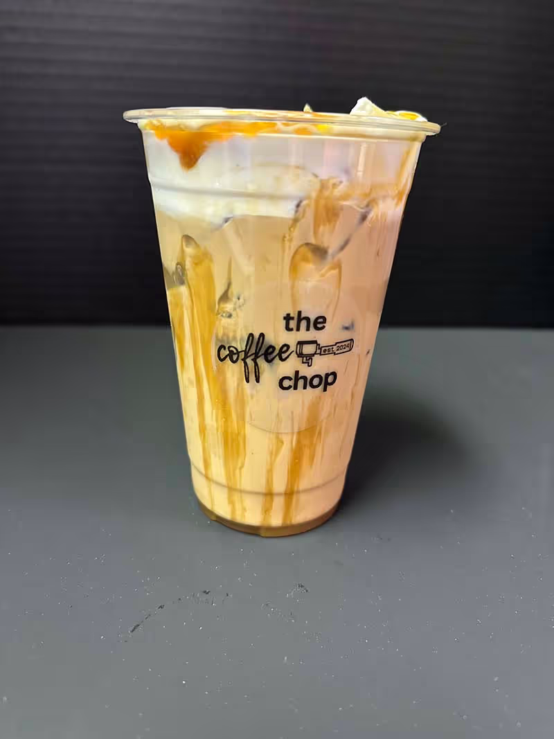 A cup of coffee with a logo on the side.