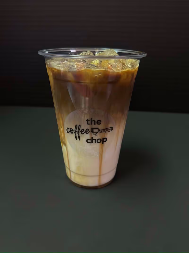 A cup of coffee with a logo on the side.