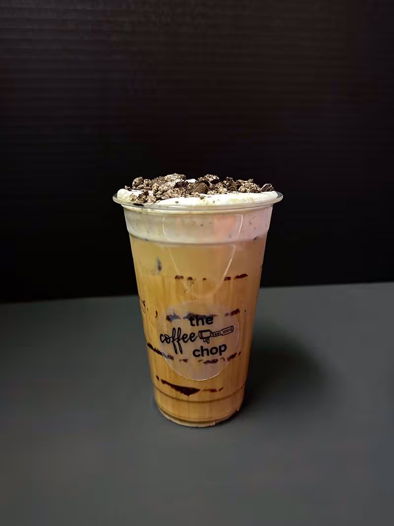 A cup of coffee with a logo on the side.