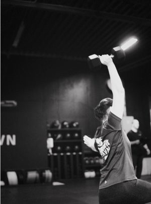 A man performs a workout at CrossFit Ravn Fitness gym in Førresfjorden, Norway, showcasing strength and determination.