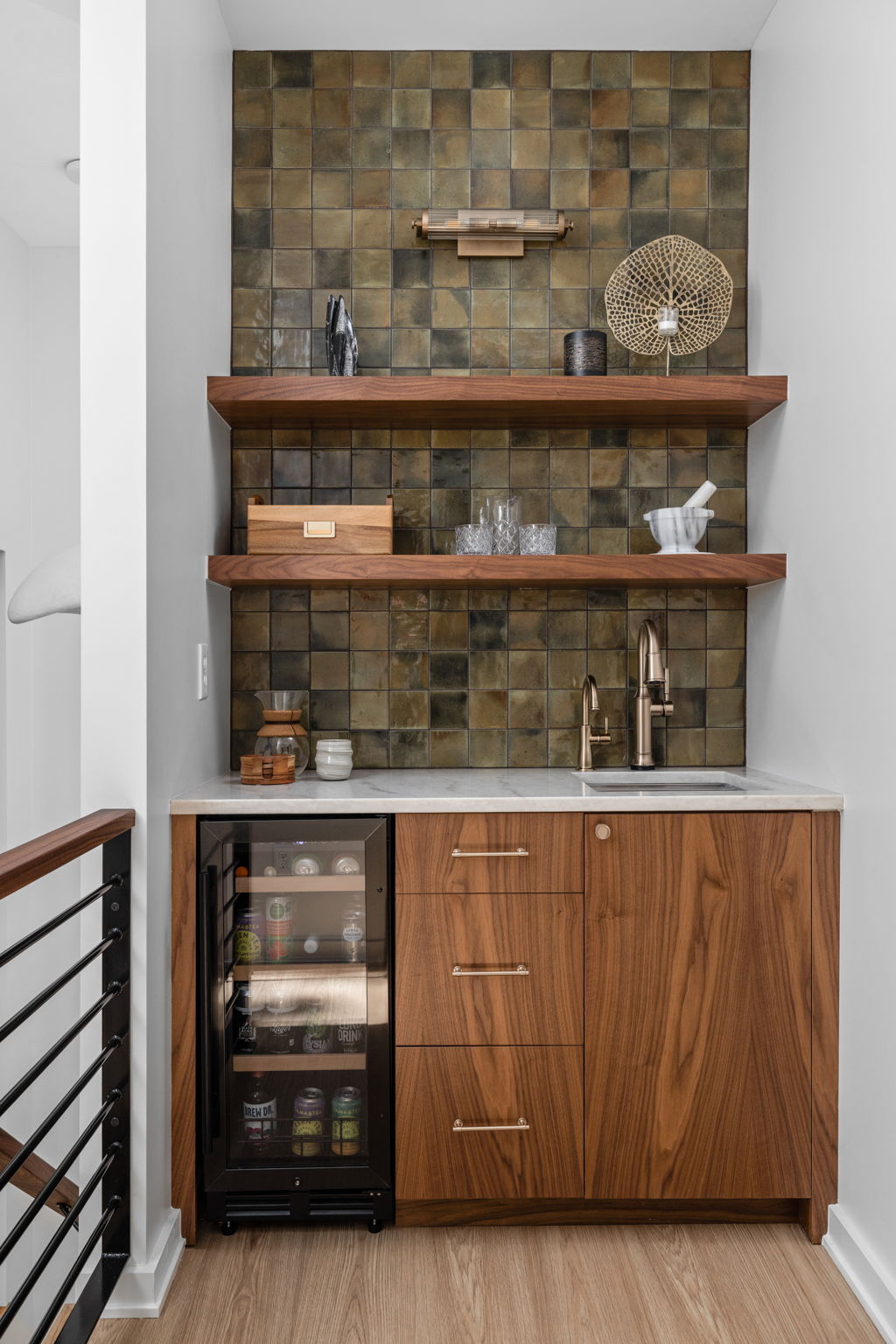 Custom wet bar with wood cabinets and stone backsplash – Entertaining space in modern home addition by Emergent Construction.