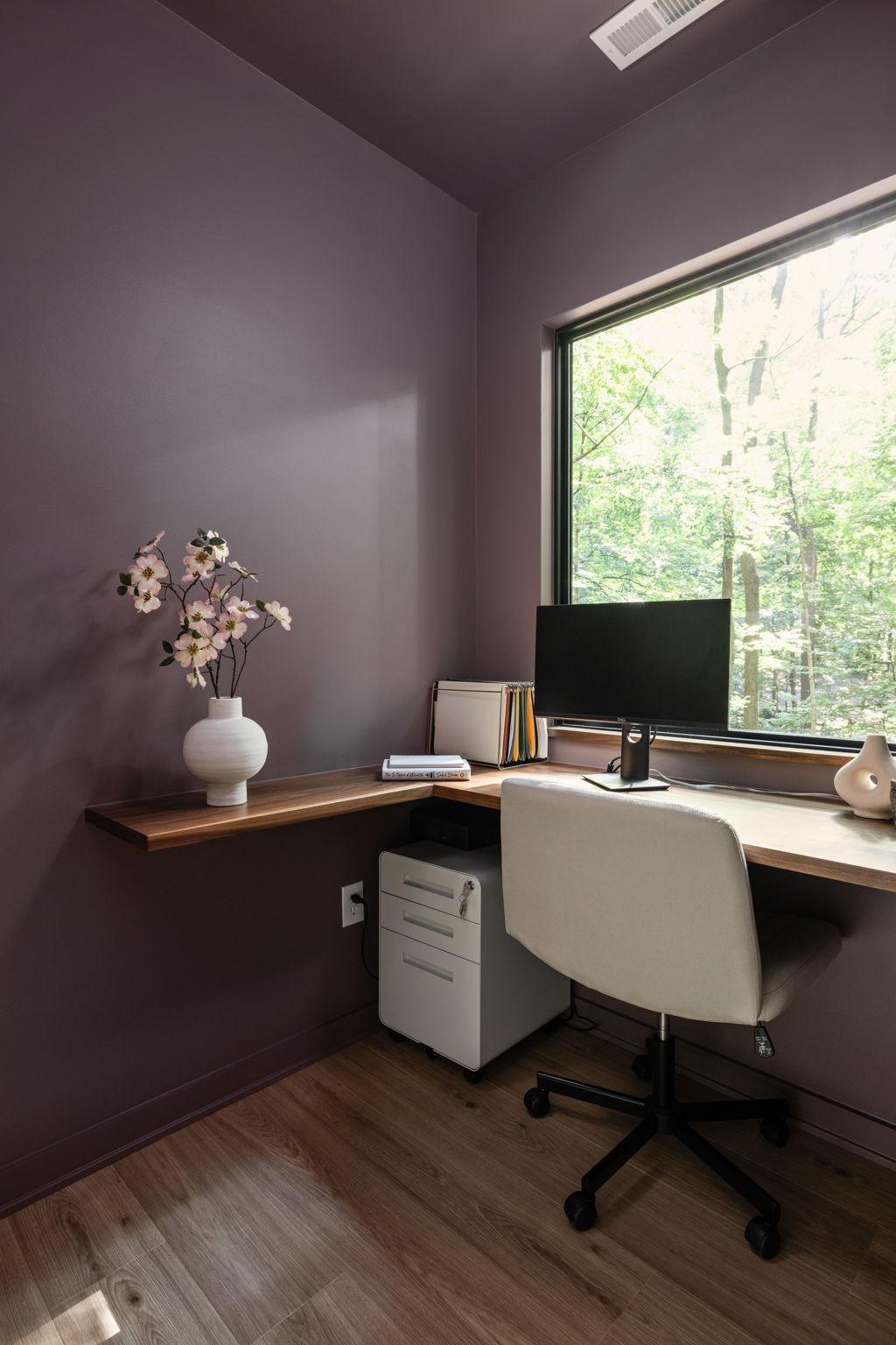 Compact home office with corner desk and natural light – Micro-office addition designed for productivity by Emergent Construction.