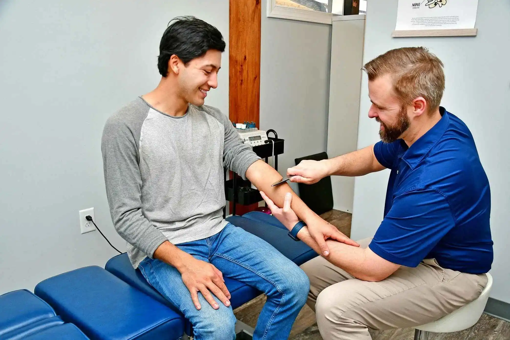 Dr. Shawn Currie performing the Graston technique on a patient.