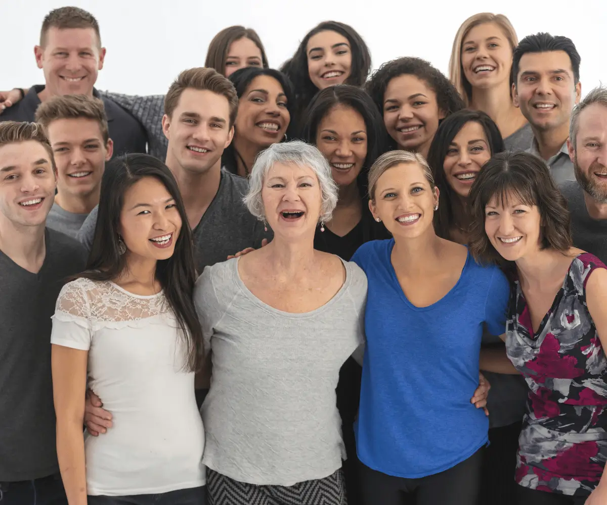 Diverse group of people of various ages smiling together, representing the supportive Kiltz Health community.
